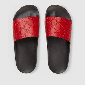 Red embossed Gucci slides